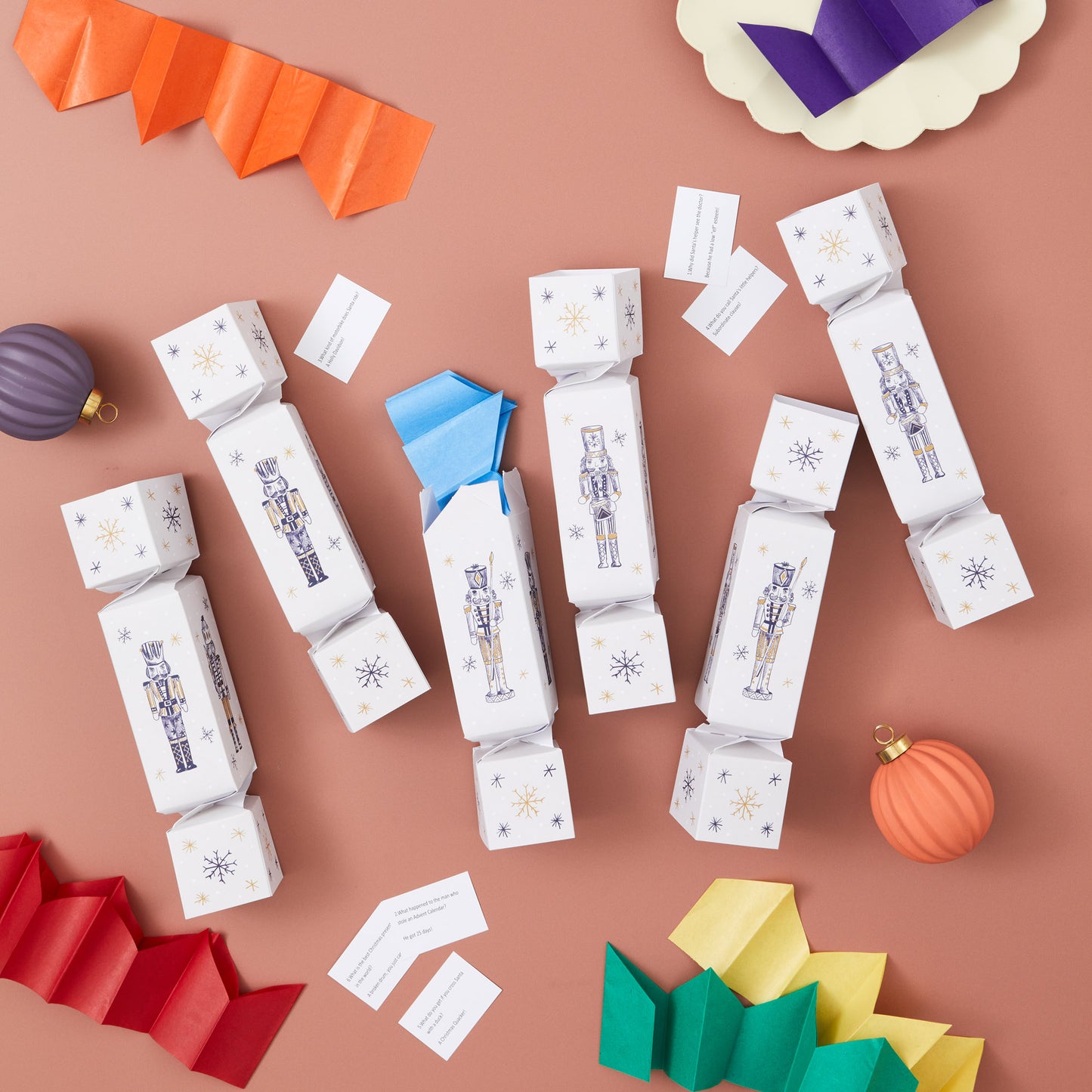 Decorative cracker boxes with Christmas-themed illustrations on a brown background