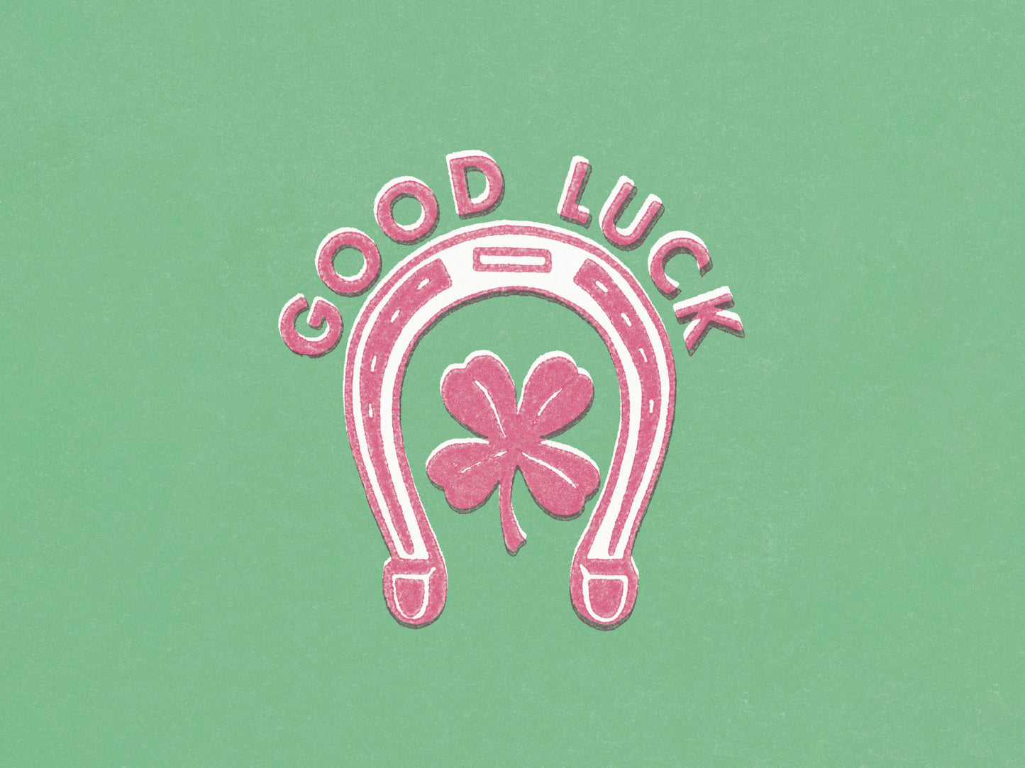 A pink and white horseshoe and clover design against a green background, with pink text: 'GOOD LUCK'.