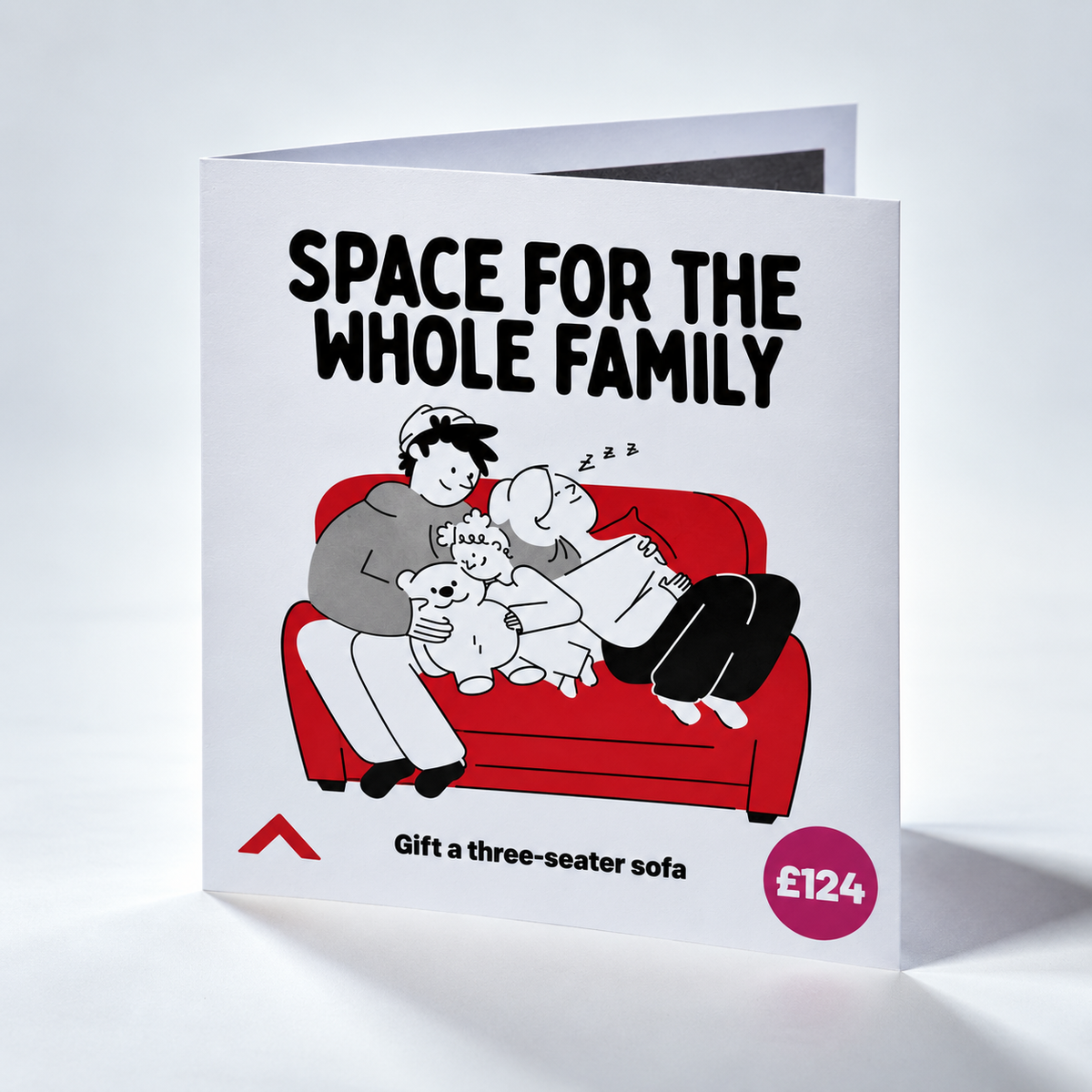 A folded greeting card or gift card shown standing open on a white background. The front features the text 'SPACE FOR THE WHOLE FAMILY' above a cartoon family hugging on a red sofa, with 'Gift a three-seater sofa' and a price '£124' printed below.