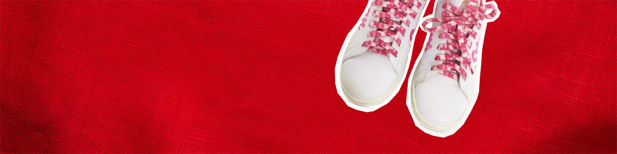 A pair of white trainers with pink laces on a red background. Text reads '30% off 1000s of preloved items'