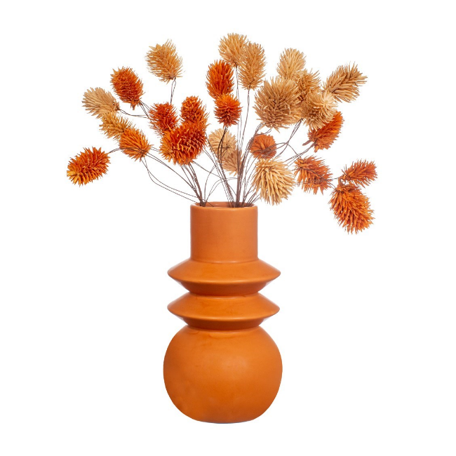 terracotta vase with dried flowers inside