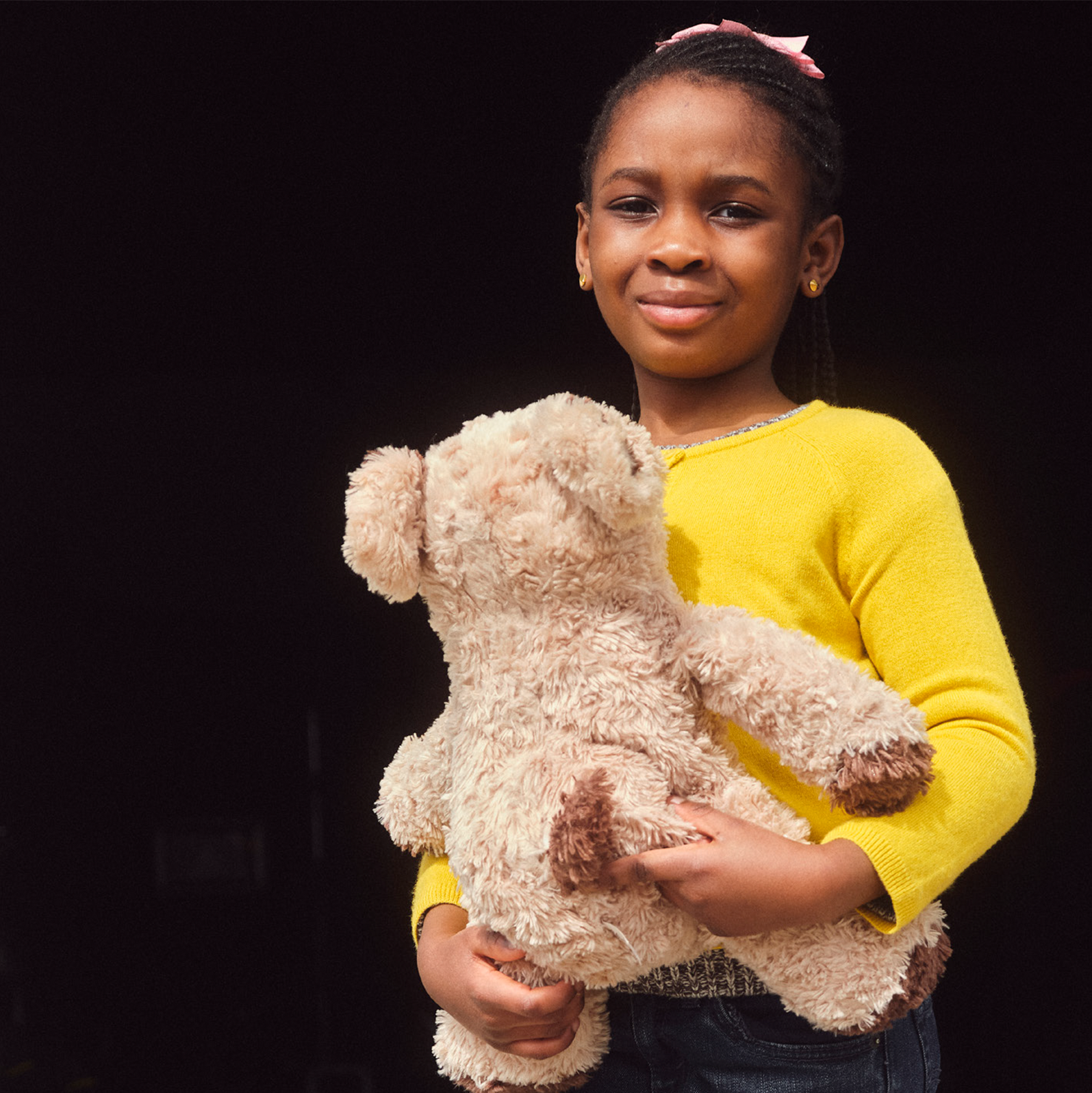 child holding a teddy bear