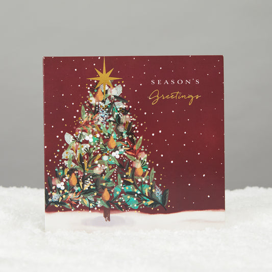 square deep red card with shiny christmas tree and gold star. Card reads season's greetings