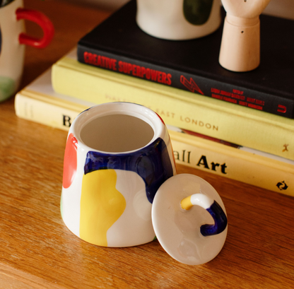 open trinket box taken against a teak desk with books in the background